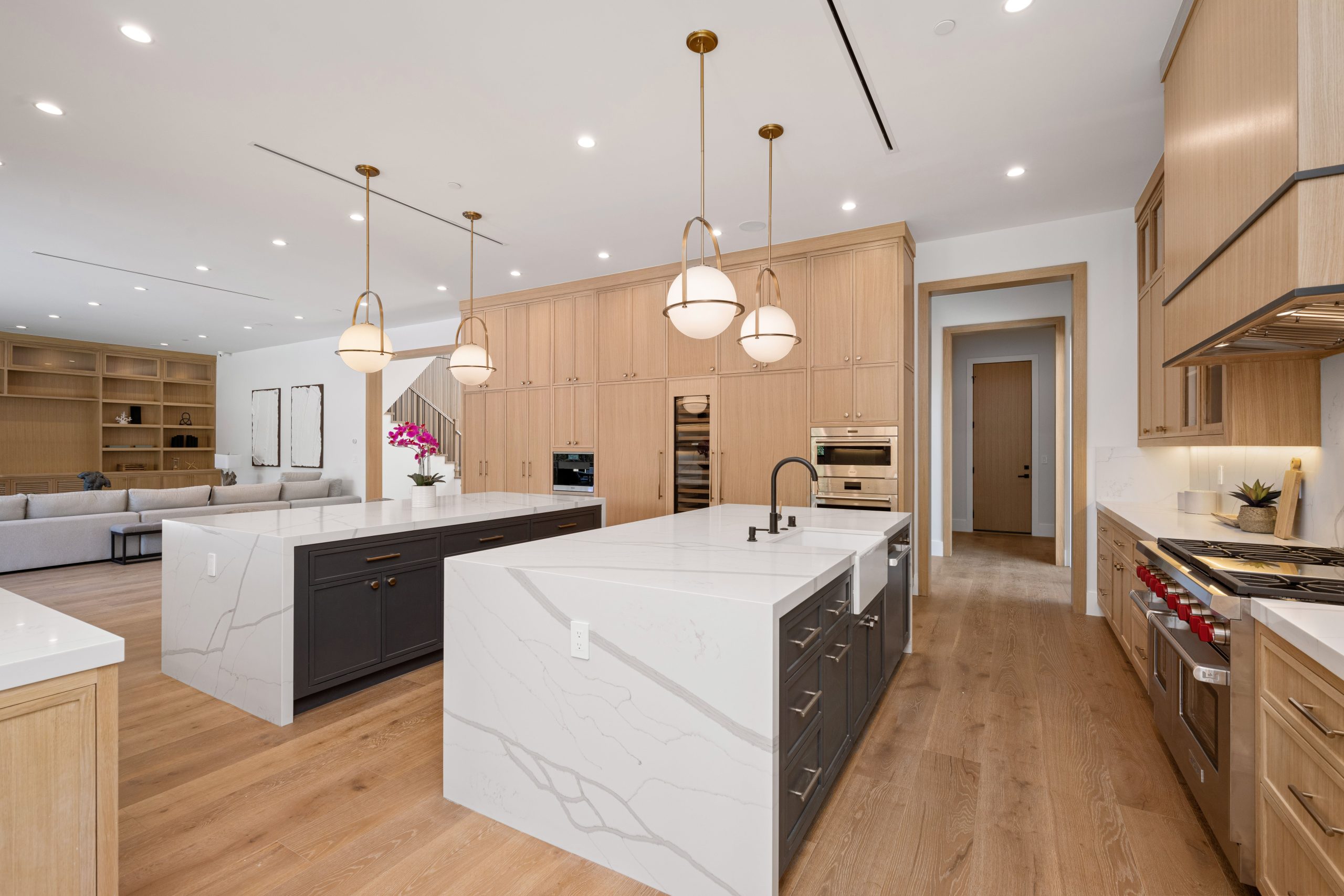 Modern kitchen with double islands and pendant lights.